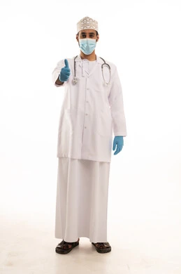 Expressions of agreement and satisfaction, following safety procedures to prevent the coronavirus, a portrait of an Arab Gulf Omani doctor wearing a dishdasha, turban, medical coat, and mask, holding a stethoscope, working in the health sector, full-body, white background.