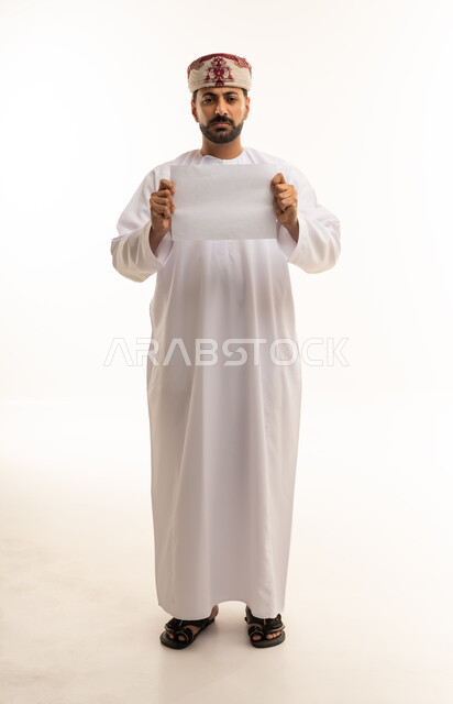 Omani Man Holding Blank Paper in Traditional Dress