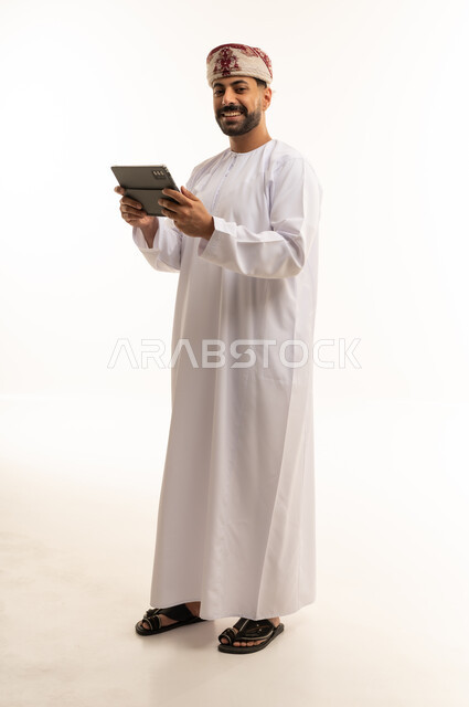 Omani Man with Tablet in Traditional Dress