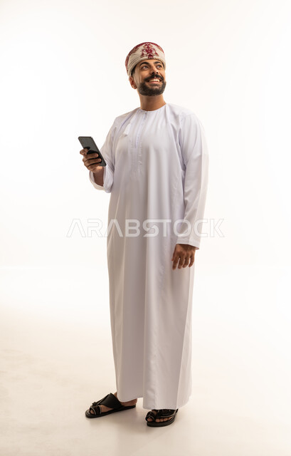 Omani Man in Traditional Dress with Smartphone