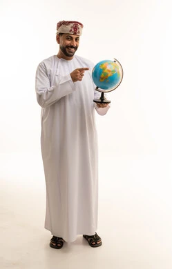 Omani Man in Traditional Dress Pointing at World Globe