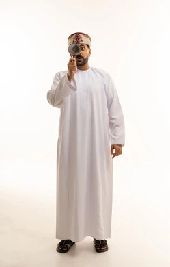Omani Man with Magnifying Glass on White Background