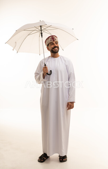 Omani Man in Traditional Dishdasha with Umbrella