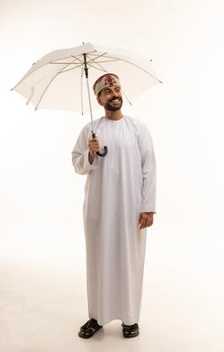 Omani Man in Traditional Dishdasha with Umbrella