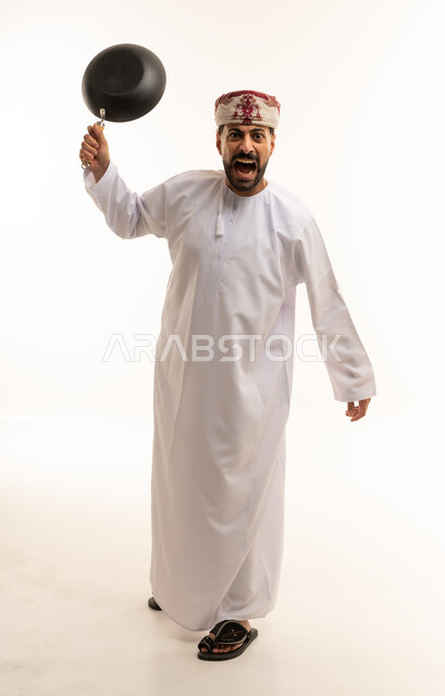 Omani Man in Traditional Dress Shouting with Frying Pan