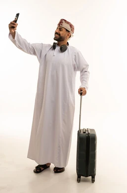 Omani Man with Suitcase Taking Selfie on White Background