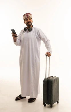Omani Man Traveler with Suitcase and Smartphone