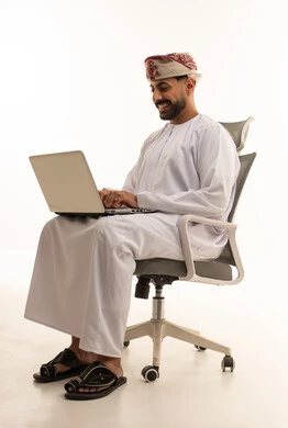 Omani Man Using Laptop in Office Chair White Background