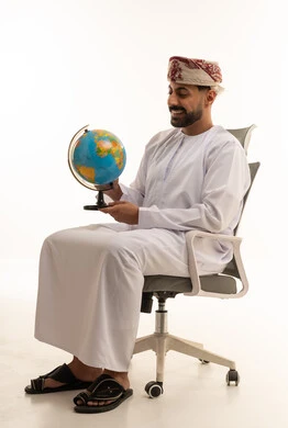 Omani Man in Traditional Dress Holding a Globe