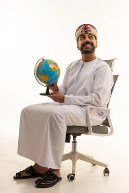 Omani Man in Traditional Dress Holding a Globe