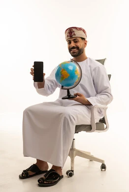 Omani Man with Globe and Smartphone in Studio