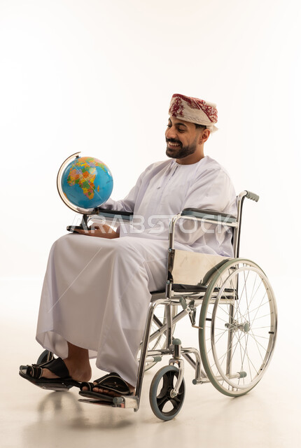 Omani Man in Wheelchair Holding Globe on White Background