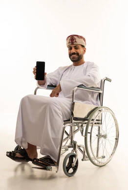 Omani Man in Wheelchair Holding Blank Smartphone