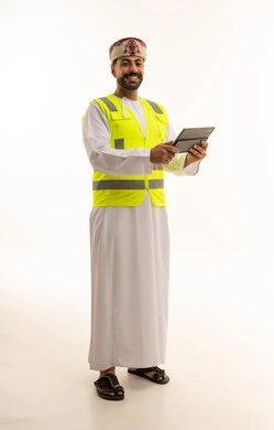Omani Professional in Safety Vest Holding Digital Tablet