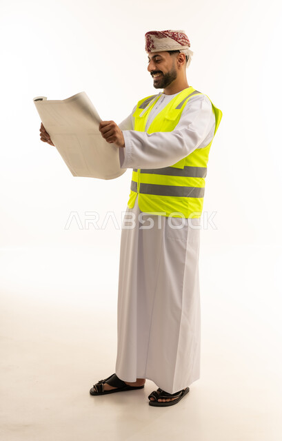 Omani Engineer with Blueprints and Safety Vest