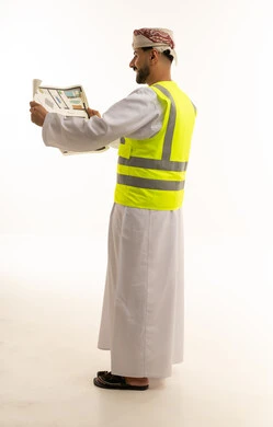 Omani Engineer in Safety Vest Holding Blueprints