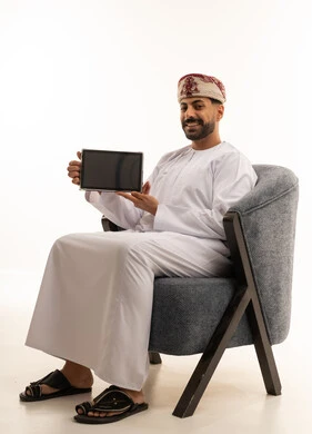 Omani Man in Traditional Dress Holding Digital Tablet