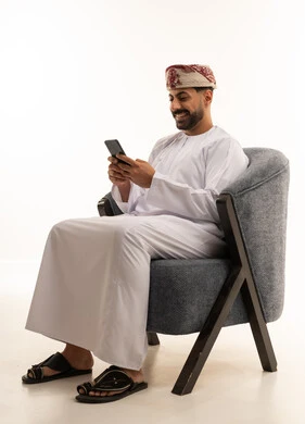 Omani Man with Smartphone in Traditional Attire