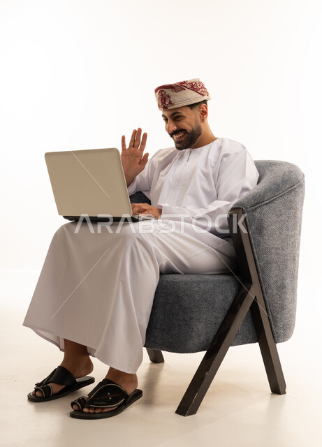Omani Man on Laptop Video Call in Traditional Dress