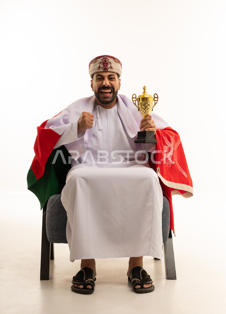 Omani Man with Golden Trophy and National Flag