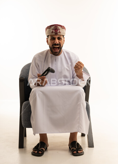 Omani Man Gaming with Excited Expression on White Background