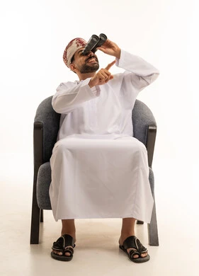 Omani Man Using Binoculars in Traditional Dress
