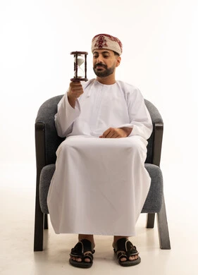 Omani Man Holding Hourglass in Traditional Dress