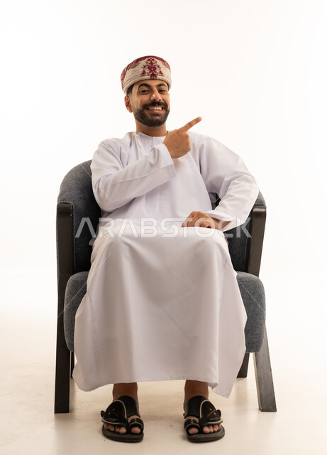 Omani Man in Traditional Dress Pointing on White Background
