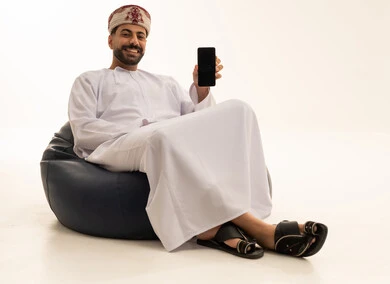 Omani Man with Smartphone on Beanbag Chair