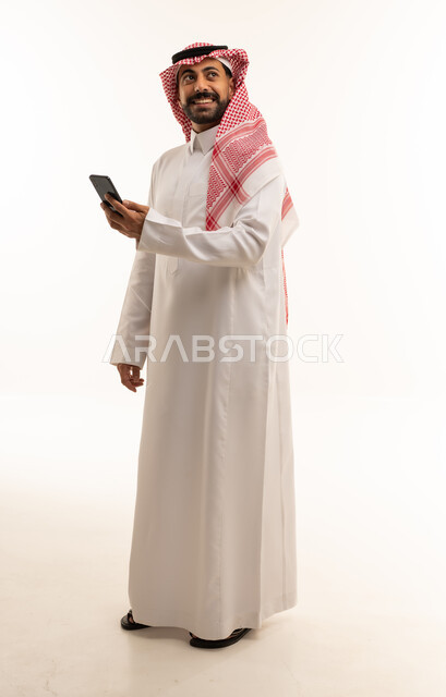 Saudi Man with Smartphone in Traditional Dress
