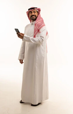Saudi Man with Smartphone in Traditional Dress