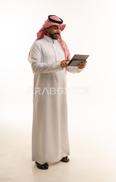 Saudi Man in Thobe Using Tablet on White Background