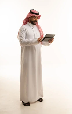 Saudi Man in Thobe Using Tablet on White Background