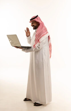 Saudi Man Waving at Laptop in Traditional Clothing