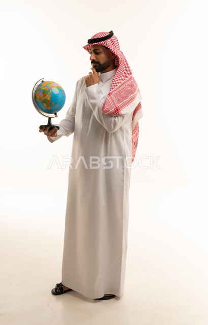 Saudi Man in Traditional Dress Holding a Globe