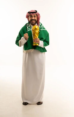 Saudi Man Holding Football Trophy in Traditional Dress