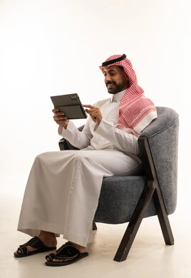 Saudi Man Using Digital Tablet on White Background Studio