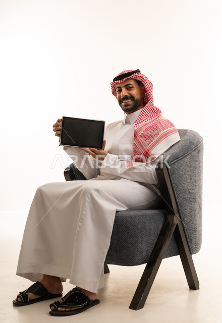 Saudi Man Holding Tablet on White Background