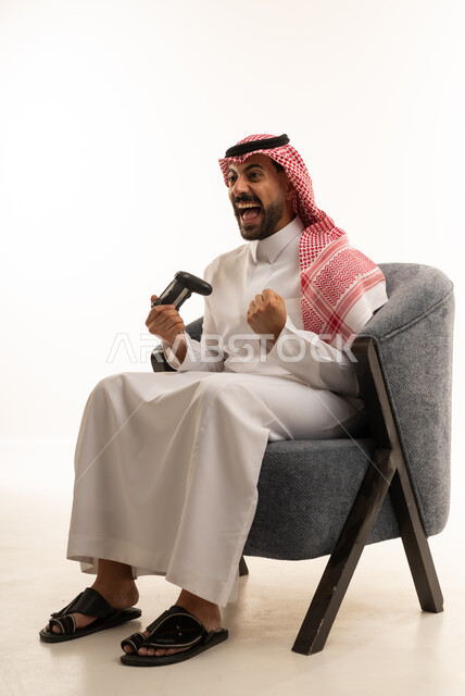 Saudi Man Playing Video Games with Victory Expression