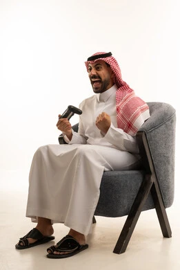 Saudi Man Playing Video Games with Victory Expression