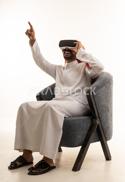 Saudi Man Using VR Goggles Pointing Upward