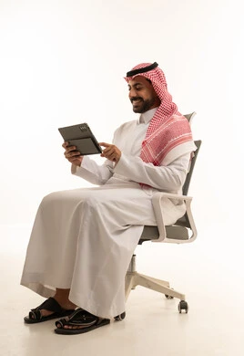 Saudi Man Using Tablet in Office Chair White Background