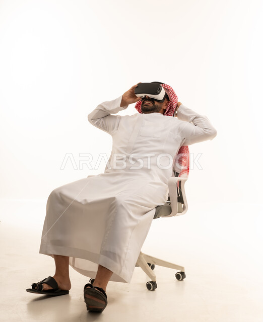 Saudi Man Wearing VR Headset on Office Chair