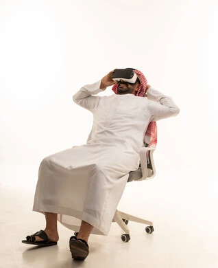 Saudi Man Wearing VR Headset on Office Chair