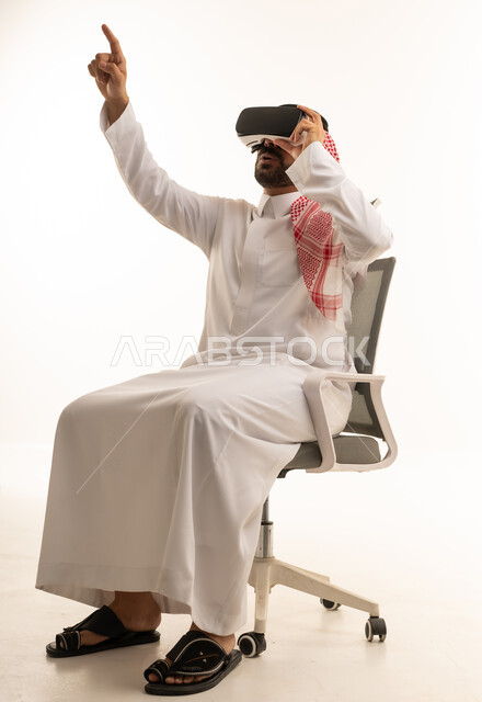 Saudi Man Using VR Headset Pointing Up in Studio
