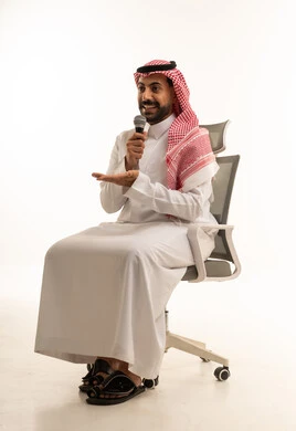 Saudi Man Speaking into Microphone on Office Chair
