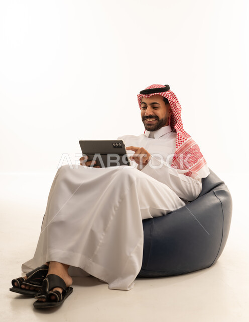 Saudi Man Using Tablet on Bean Bag Chair
