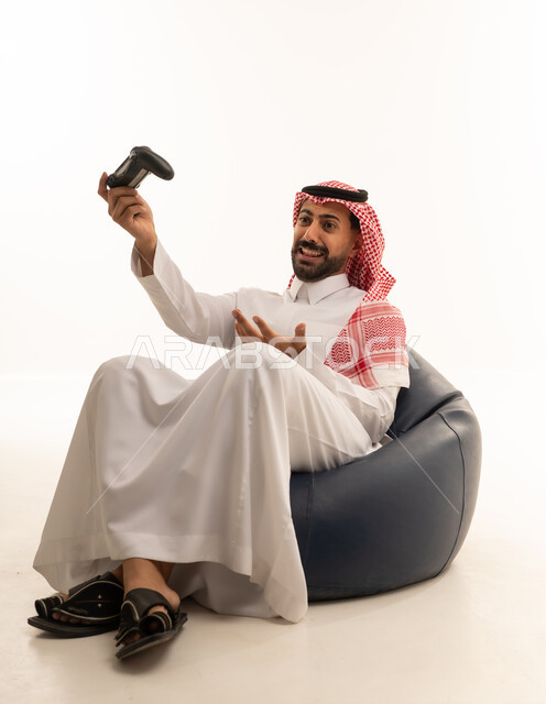 Saudi Man Playing Video Games on Bean Bag