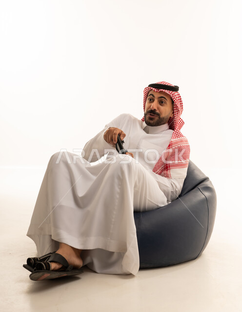Saudi Man Playing Video Games in Traditional Dress