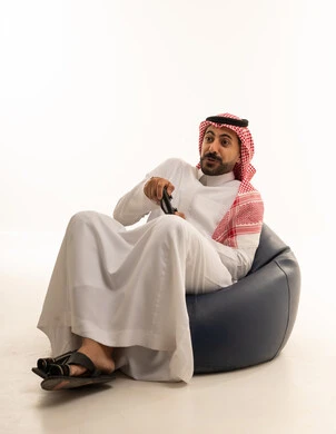 Saudi Man Playing Video Games in Traditional Dress